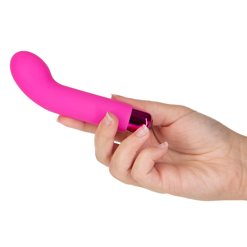 Sara's Spot Mini G-Spot Rechargeable Vibrator in pink shown out of packaging, held in hand.