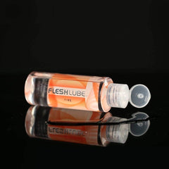 FLESHLUBE FIRE Warming 8oz Lubricant by Fleshlight bottle open on it's side