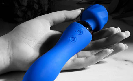 Blue vibrator in woman's hand