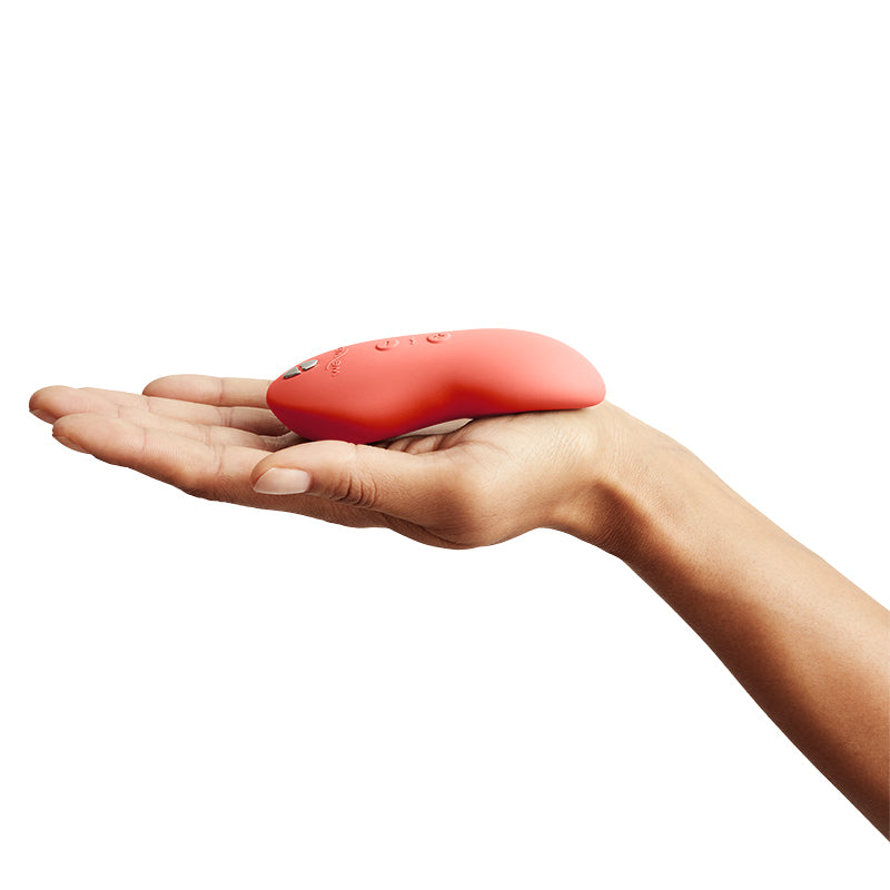 We-Vibe Touch X Magic Multitasker Vibe in coral crave - compact size in palm of hand from the side